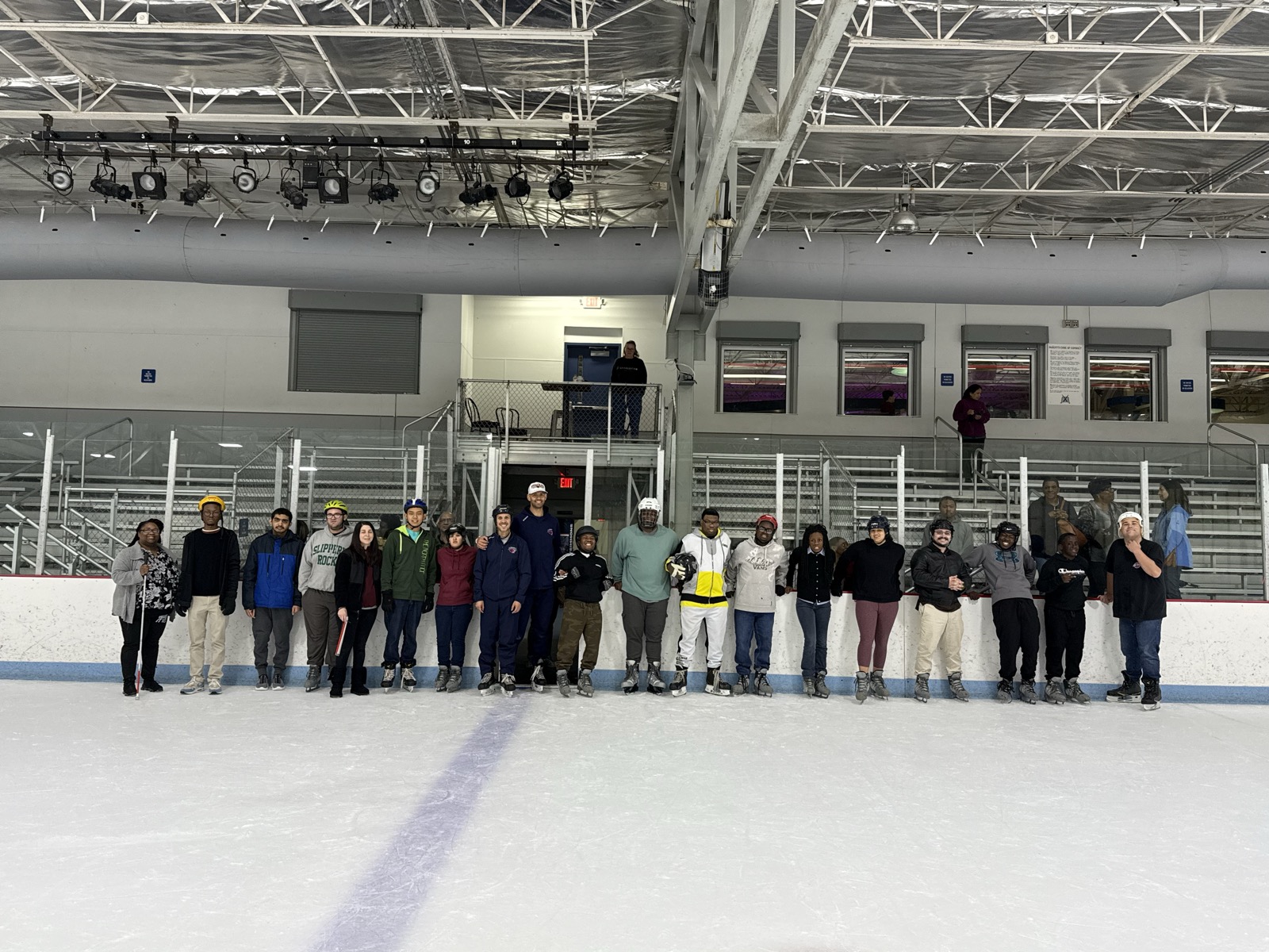 AccessAbility's Leadership Initiative Team lined up together on the ice during a group outing.