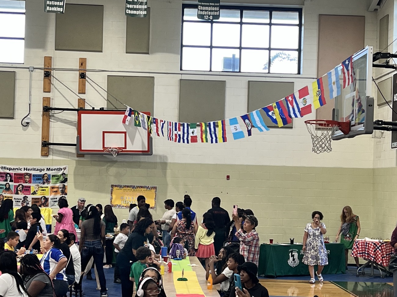People connecting with AccessAbility staff and exhibitors at a resource fair.